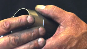Photo of hands forming an exhaust pipe compression chamber